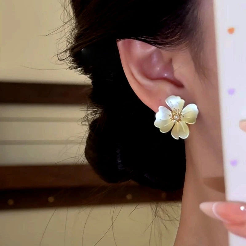 Close-up detail of the sparkling zircons and plating on the Flower Stud Earrings