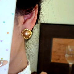 Close-up detail of the sparkling zircons and plating on the Four-Leaf Clover Studs