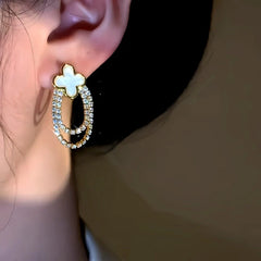 Model showcasing the dangle and style of the 14K Gold-Plated Elegant Four-Leaf Zircon Tassel Earrings