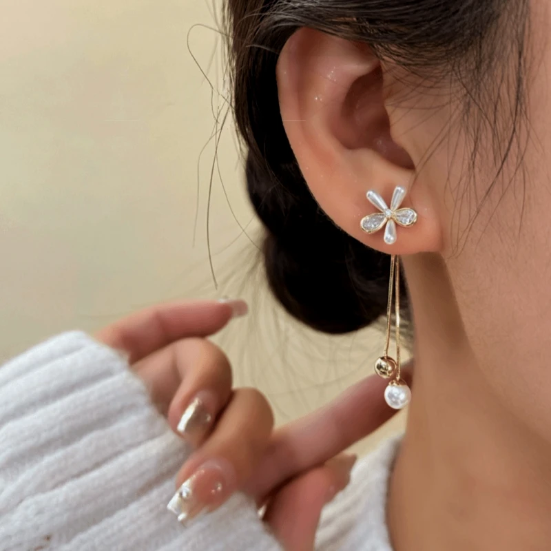 Model showcasing the dangle and style of the 14K Gold-Plated Elegant French Flower Tassel Earrings