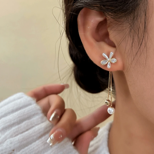 Model showcasing the dangle and style of the 14K Gold-Plated Elegant French Flower Tassel Earrings