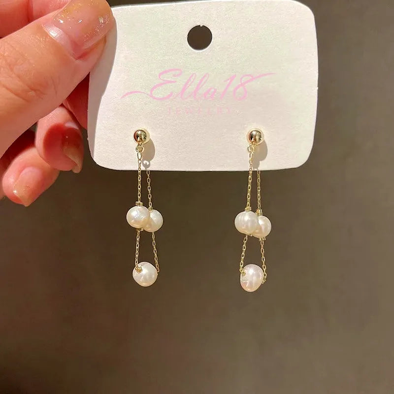Angled view of the 14K Gold-Plated Elegant Front And Back Pearl Earrings