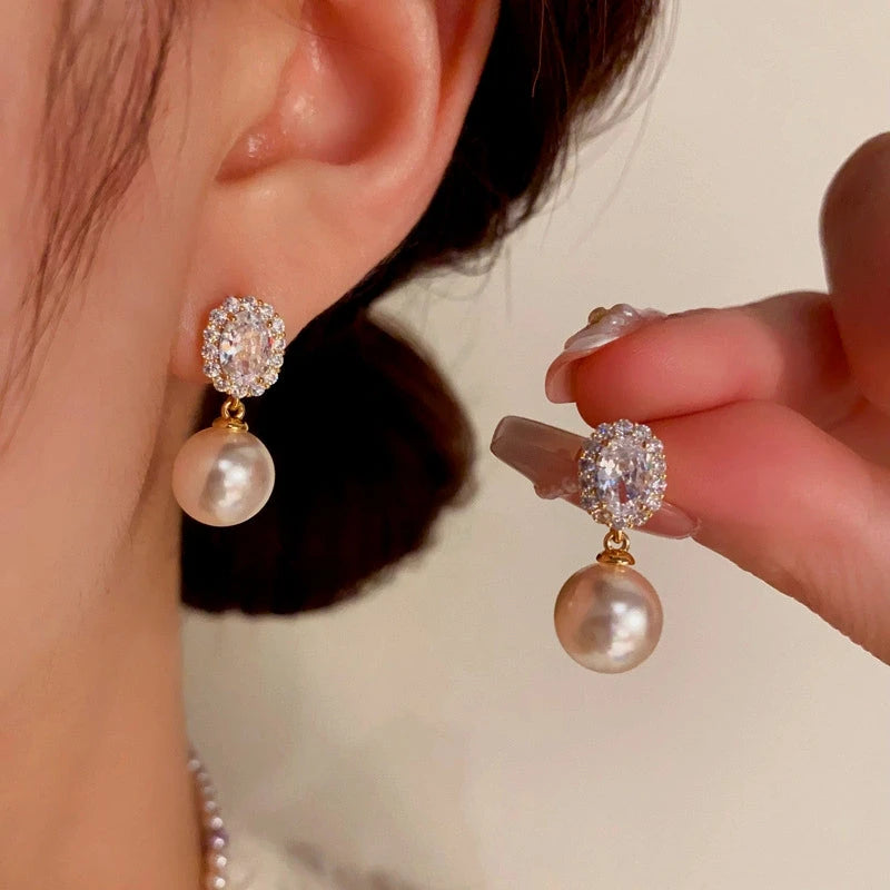 Angled view of the 14K Gold-Plated Elegant Gemstone Pearl Earrings