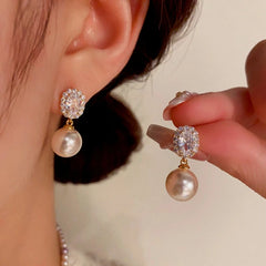 Angled view of the 14K Gold-Plated Elegant Gemstone Pearl Earrings