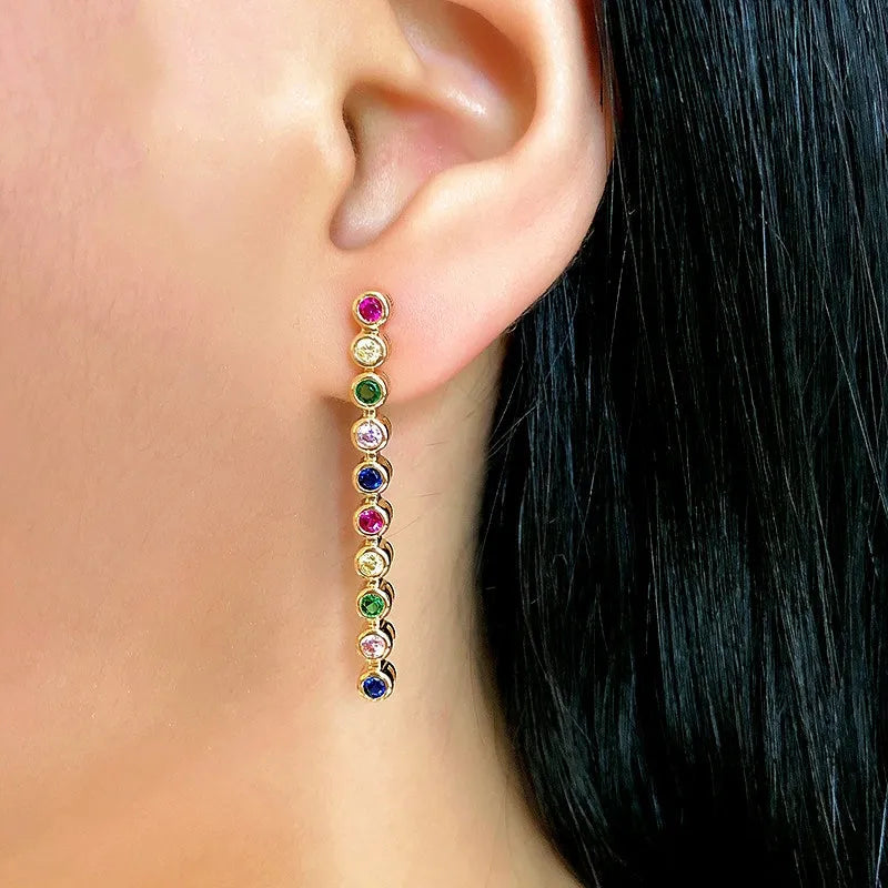 Model showcasing the dangle and style of the 14K Gold-Plated Elegant Gemstone Tassel Earrings