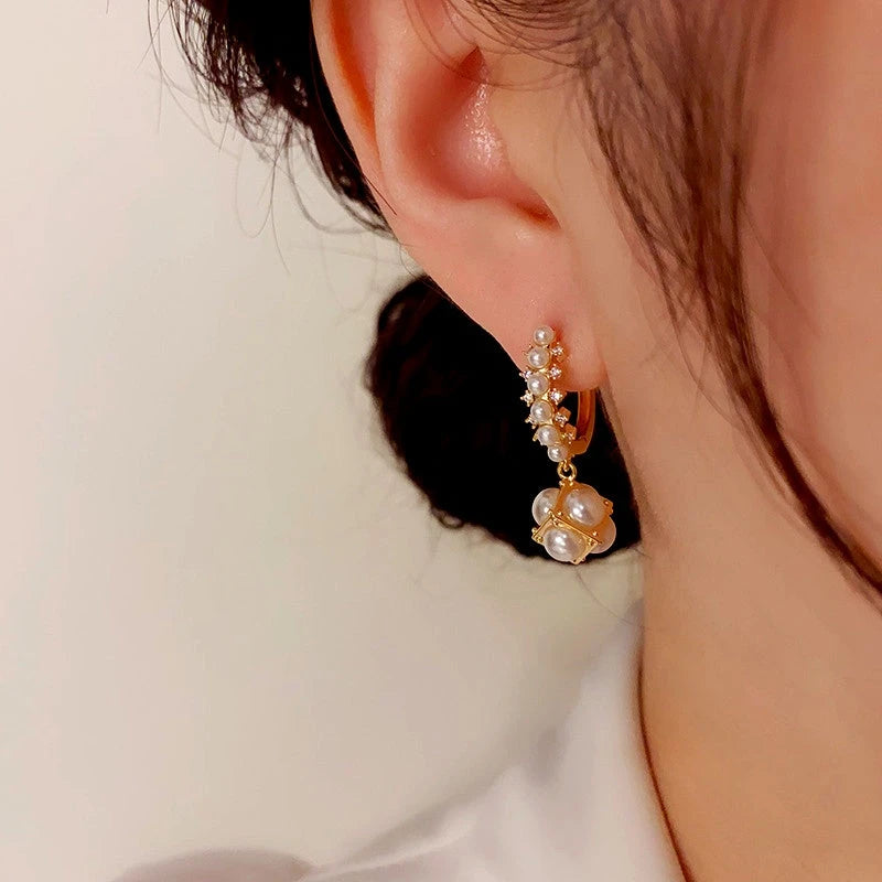 Close-up detail of the sparkling zircons and plating on the Pearl Ball Earrings