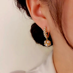 Close-up detail of the sparkling zircons and plating on the Pearl Ball Earrings