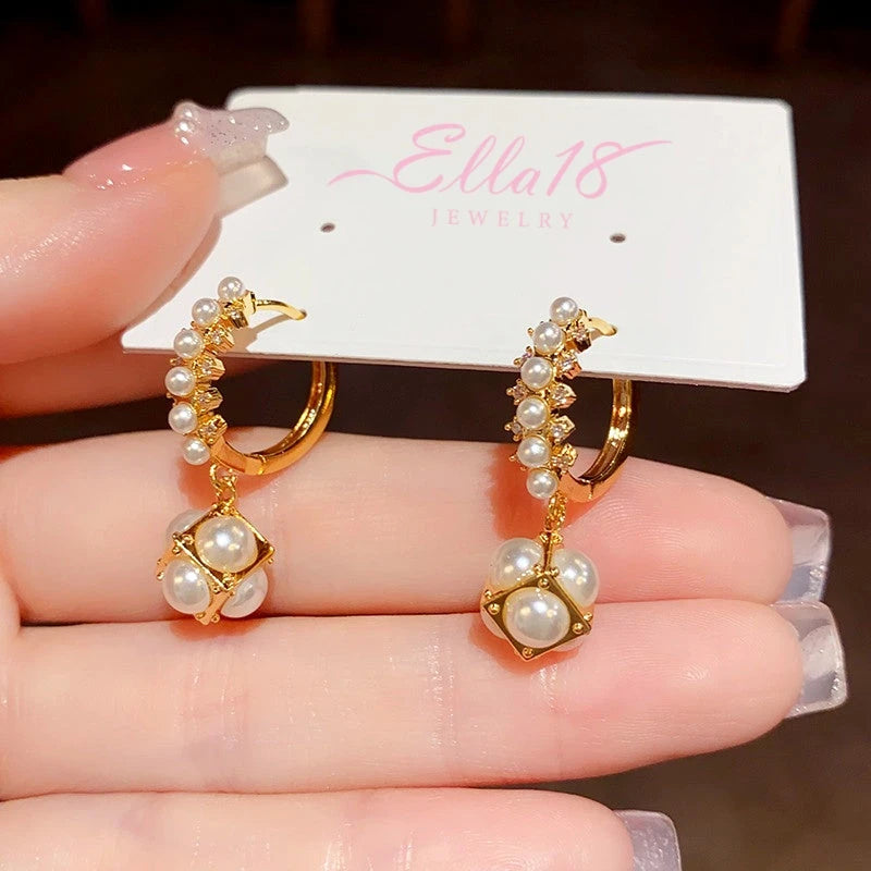 Angled view of the 14K Gold-Plated Elegant Gentle Pearl Ball Earrings