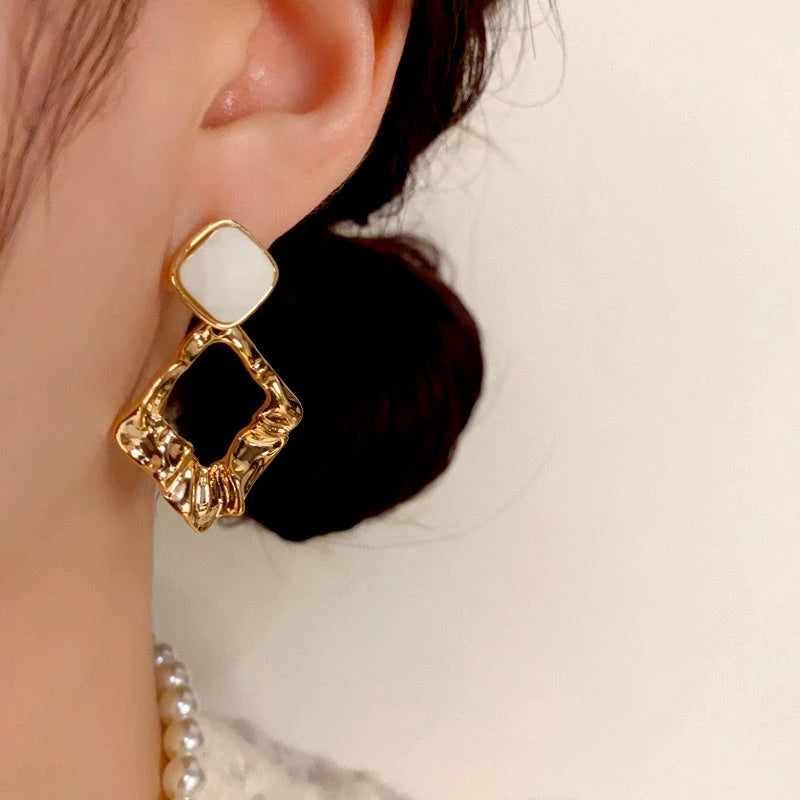 Close-up detail of the sparkling zircons and plating on the Geometric Diamond Earrings