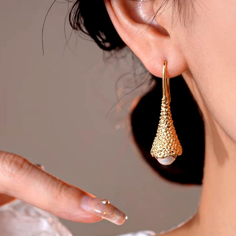 Model showcasing the dangle and style of the 14K Gold-Plated Elegant Geometric Pearl Ear Hooks