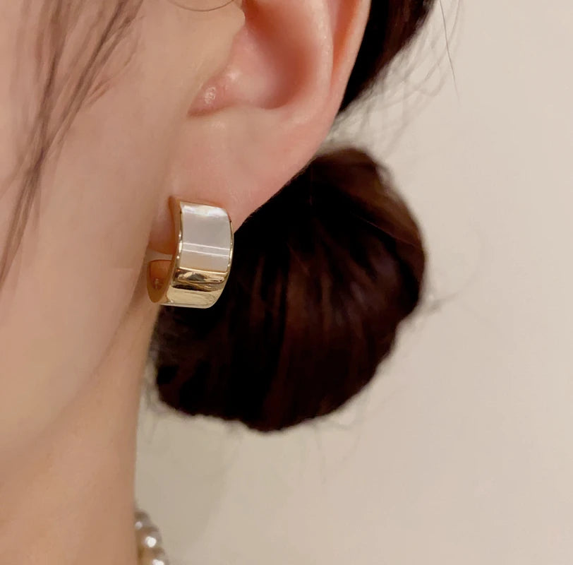 Model showcasing the dangle and style of the 14K Gold-Plated Elegant Geometric Shell C-Shaped Earrings