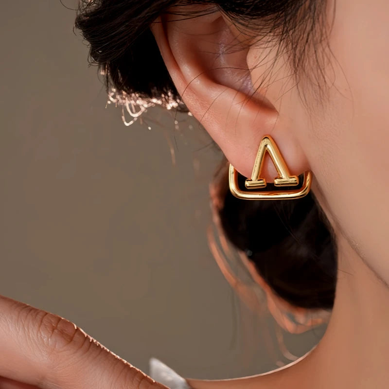 Model showcasing the dangle and style of the 14K Gold-Plated Elegant Geometric Square Letter Earrings