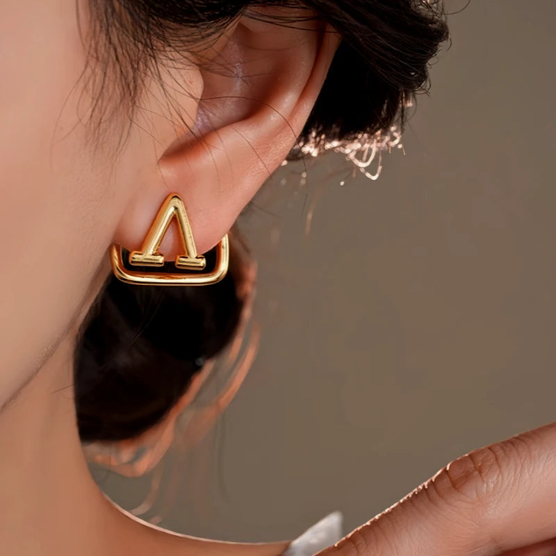 Close-up detail of the sparkling zircons and plating on the Square Letter Ear Jackets