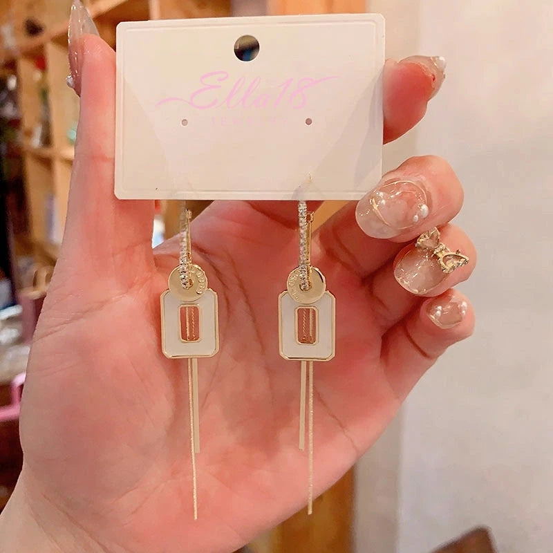Model showcasing the dangle and style of the 14K Gold-Plated Elegant Geometric Square Long Tassel Earrings