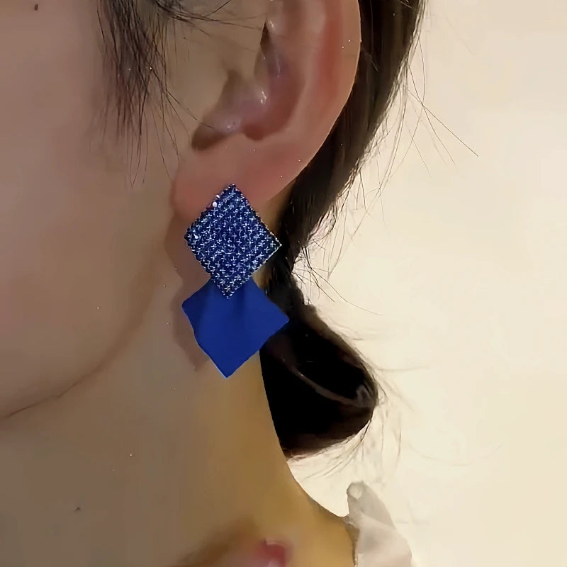 Model showcasing the dangle and style of the 14K Gold-Plated Elegant Geometric Vintage Earrings