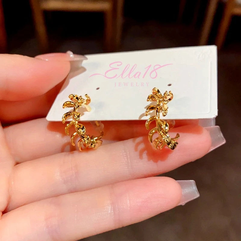 Angled view of the 14K Gold-Plated Elegant Metal Leaf C-Shaped Earrings