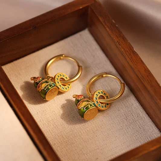 Model showcasing the dangle and style of the 14K Gold-Plated Elegant Gourd Fortune Earrings