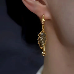 Close-up detail of the sparkling zircons and plating on the Leaf Earrings