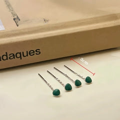 Angled view of the 14K Gold-Plated Elegant Green Bean Threader Earrings