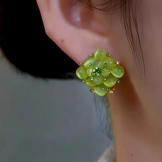 Model showcasing the dangle and style of the 14K Gold-Plated Elegant Green Cat's Eye Stone Square Earrings