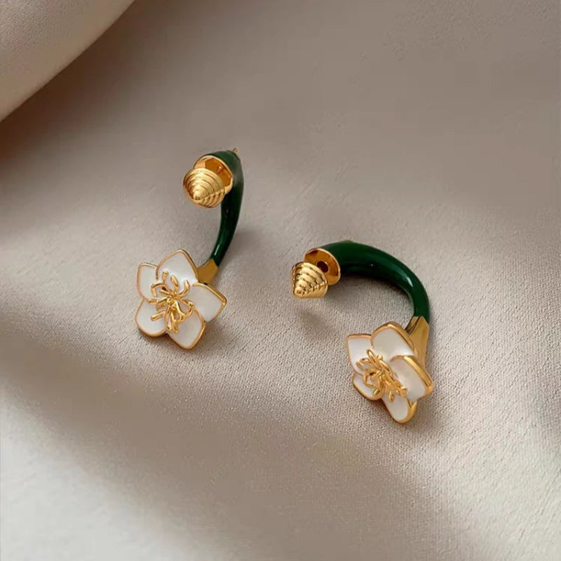 Model showcasing the dangle and style of the 14K Gold-Plated Elegant Green Enamel Drip Glaze Flower Earrings