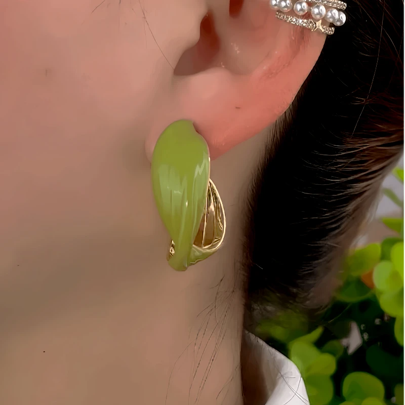 Close-up detail of the sparkling zircons and plating on the Green Hoop Earrings