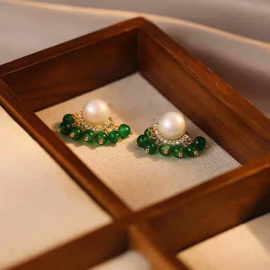 Model showcasing the dangle and style of the 14K Gold-Plated Elegant Green Pearl Tassel Earrings