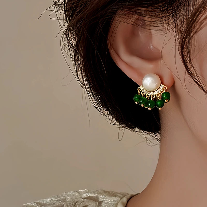 Angled view of the 14K Gold-Plated Elegant Green Pearl Tassel Earrings