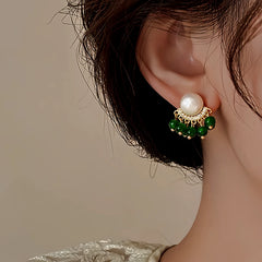 Angled view of the 14K Gold-Plated Elegant Green Pearl Tassel Earrings