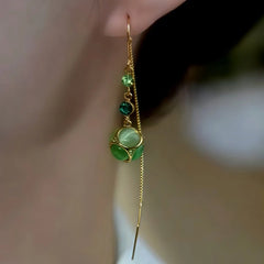 Model showcasing the dangle and style of the 14K Gold-Plated Elegant Green Zircon Diamond Cat's Eye Stone Threader Earrings