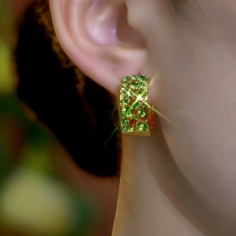 Model showcasing the dangle and style of the 14K Gold-Plated Elegant Green Zircon Diamond Hoop Earrings