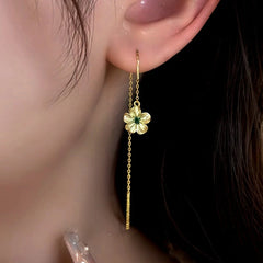 Model showcasing the dangle and style of the 14K Gold-Plated Elegant Green Zircon Diamond Threader Earrings