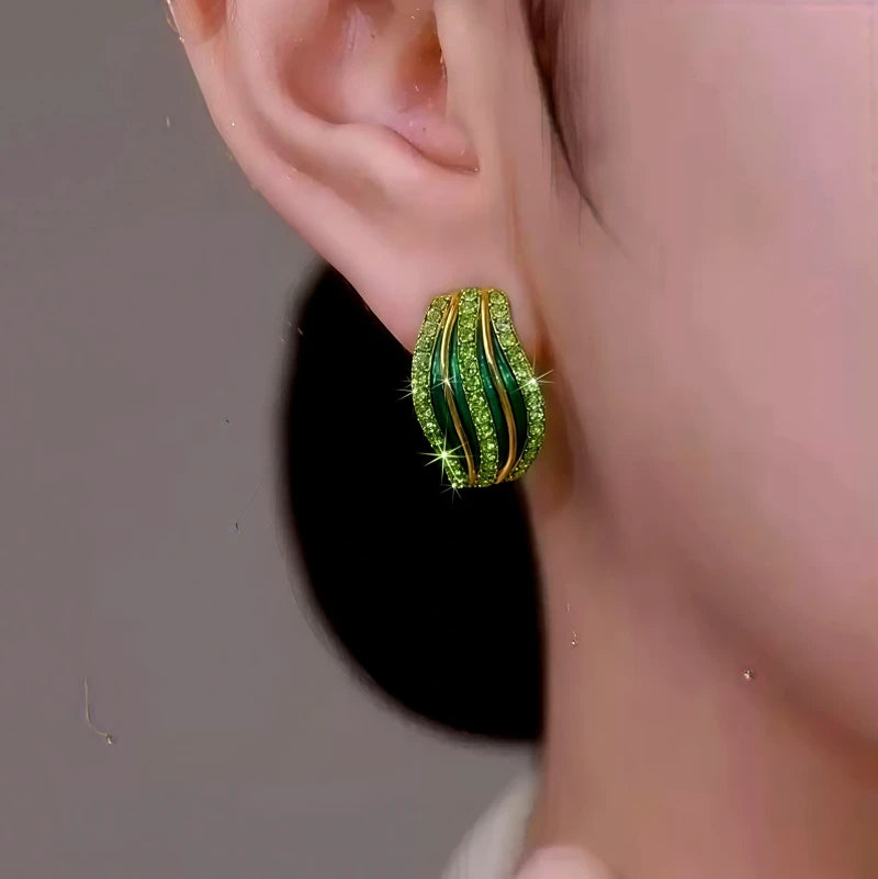 Model showcasing the dangle and style of the 14K Gold-Plated Elegant Green Zircon Line Stud Earrings