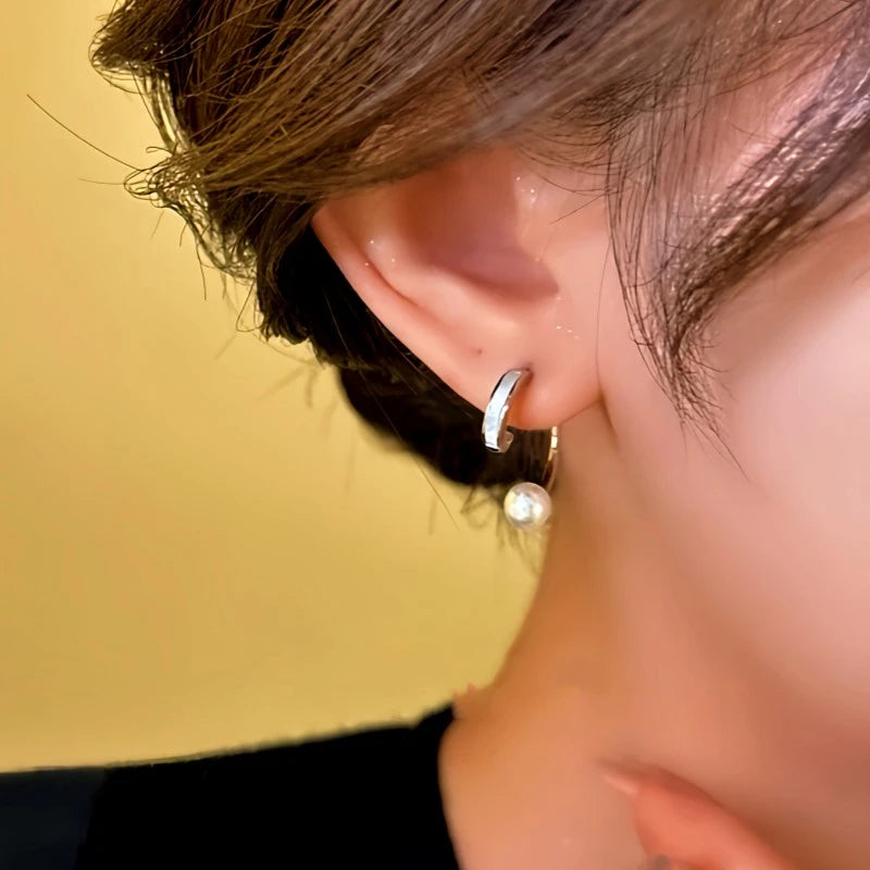 Model showcasing the dangle and style of the 14K Gold-Plated Elegant Half-Circle Bead Earrings