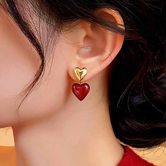 Model showcasing the dangle and style of the 14K Gold-Plated Elegant Heart-Design Earrings