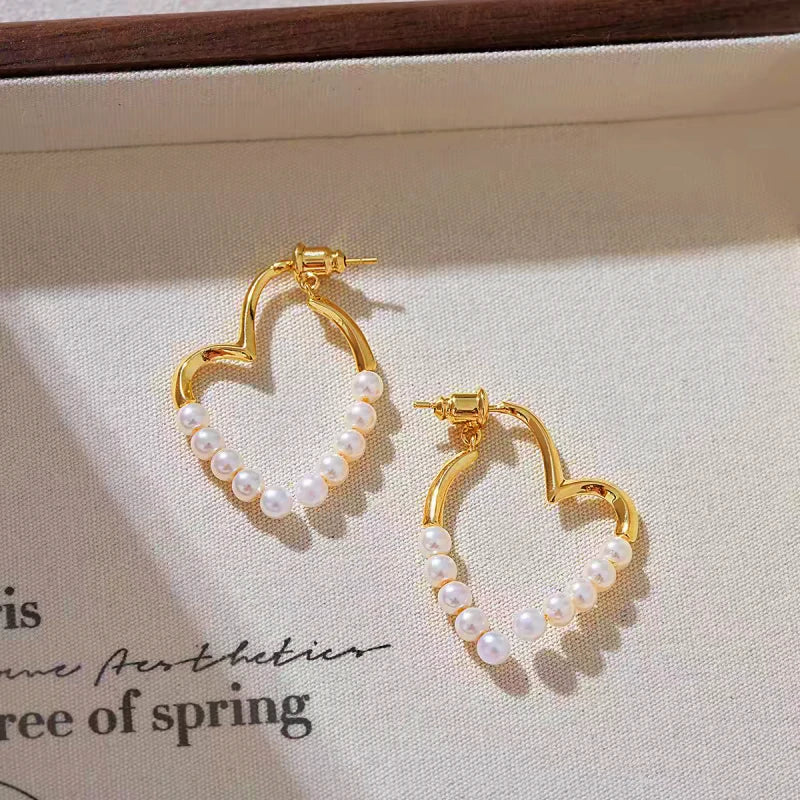 Angled view of the 14K Gold-Plated Elegant Heart-Design Pearl Earrings