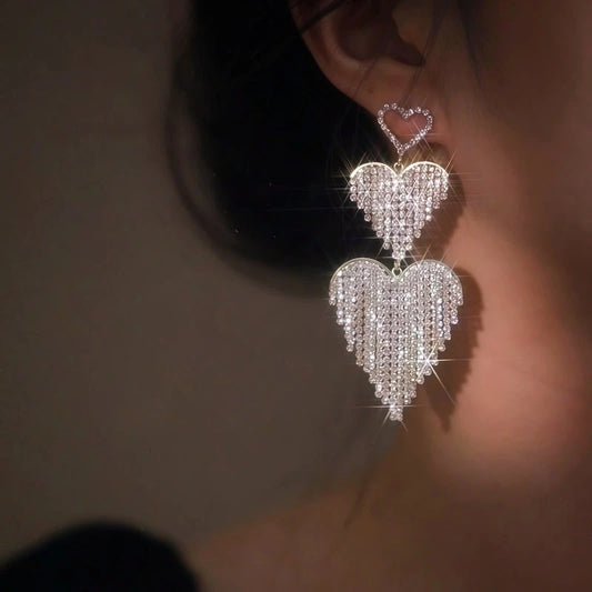 Model showcasing the dangle and style of the 14K Gold-Plated Elegant Heart-Design Rhinestone Tassel Earrings