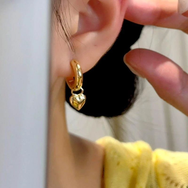 Close-up detail of the sparkling zircons and plating on the Gold Heart Earrings