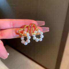 Close-up detail of the sparkling zircons and plating on the Heart Pearl Earrings