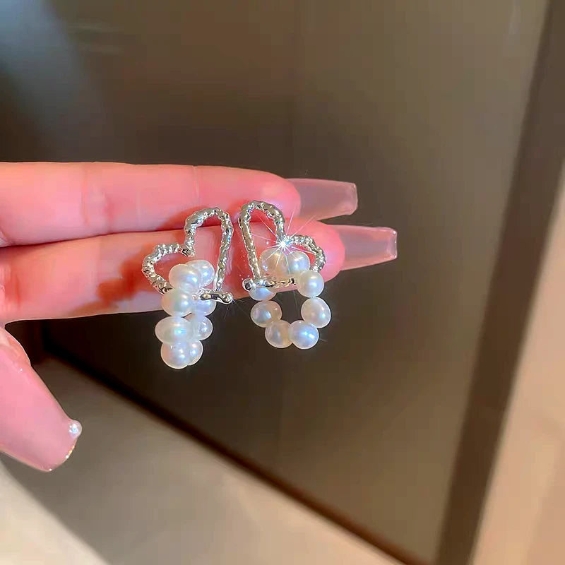 Angled view of the 14K Gold-Plated Elegant Heart Pearl Tassel Earrings