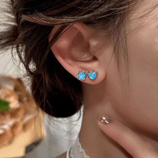 Model showcasing the dangle and style of the 14K Gold-Plated Elegant Heart Star Stud Earrings