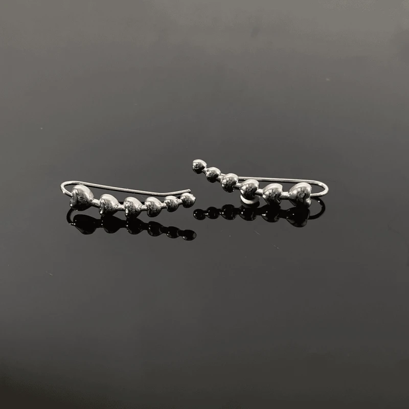 Close-up detail of the sparkling zircons and plating on the Heart Crawler Earrings