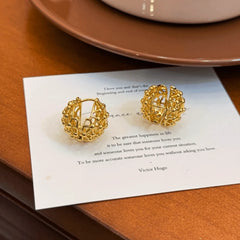 Angled view of the 14K Gold-Plated Elegant Hollow Basket Earrings