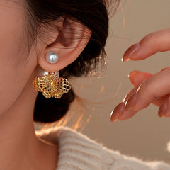 Close-up detail of the sparkling zircons and plating on the Butterfly Pearl Earrings