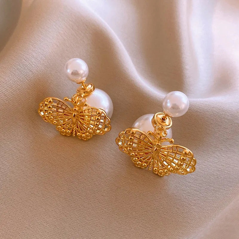 Angled view of the 14K Gold-Plated Elegant Hollow Butterfly Pearl Earrings