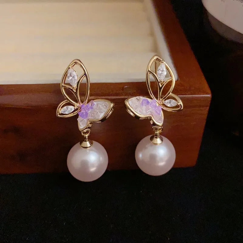 Close-up detail of the sparkling zircons and plating on the Butterfly Pearl Earrings