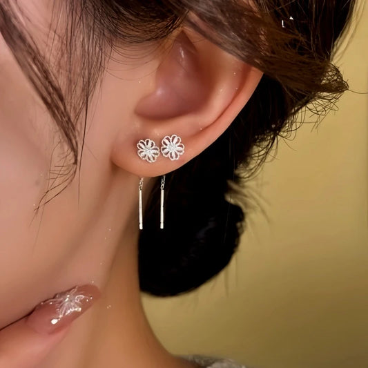 Model showcasing the dangle and style of the 14K Gold-Plated Elegant Hollow Filigree Flower Threader Earrings