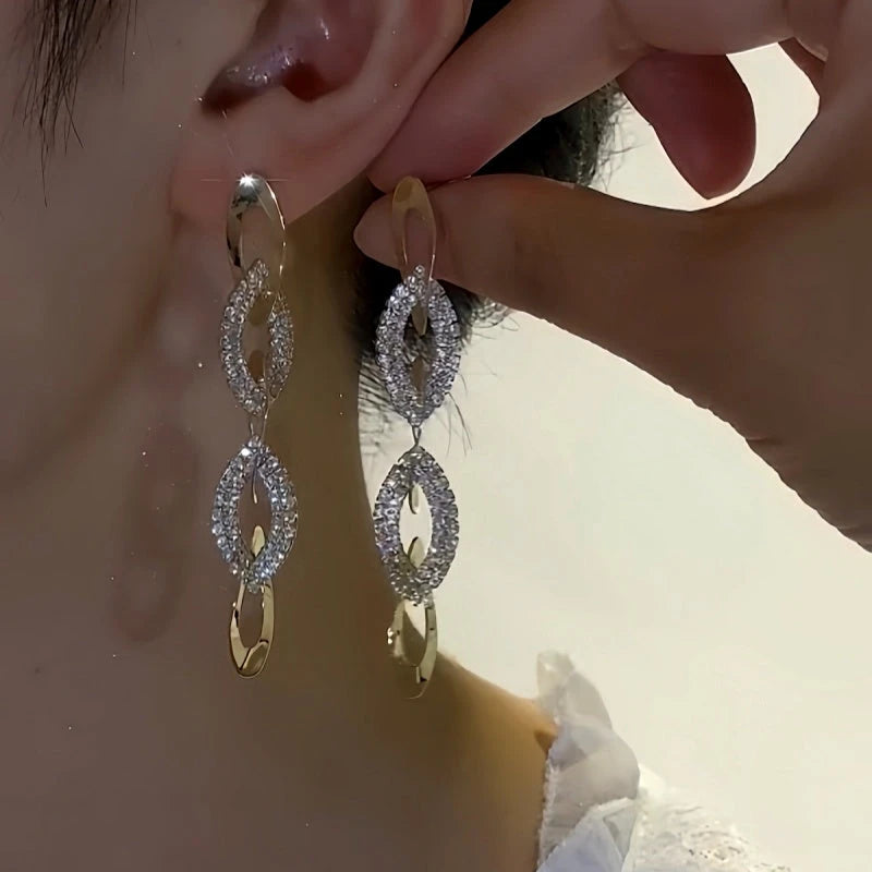 Close-up detail of the sparkling zircons and plating on the Interlocking Diamond Earrings