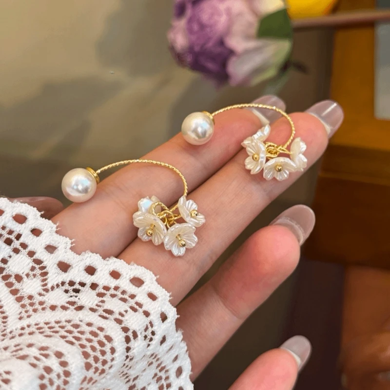 Model showcasing the dangle and style of the 14K Gold-Plated Elegant Jasmine Spike Flower Bead Earrings