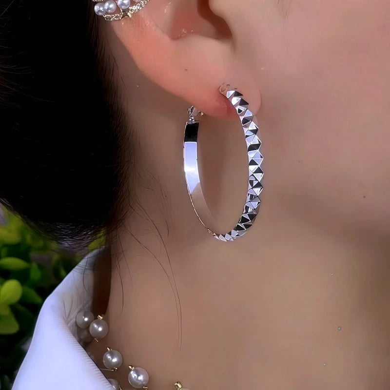 Model showcasing the dangle and style of the 14K Gold-Plated Elegant Large Hoop Earrings